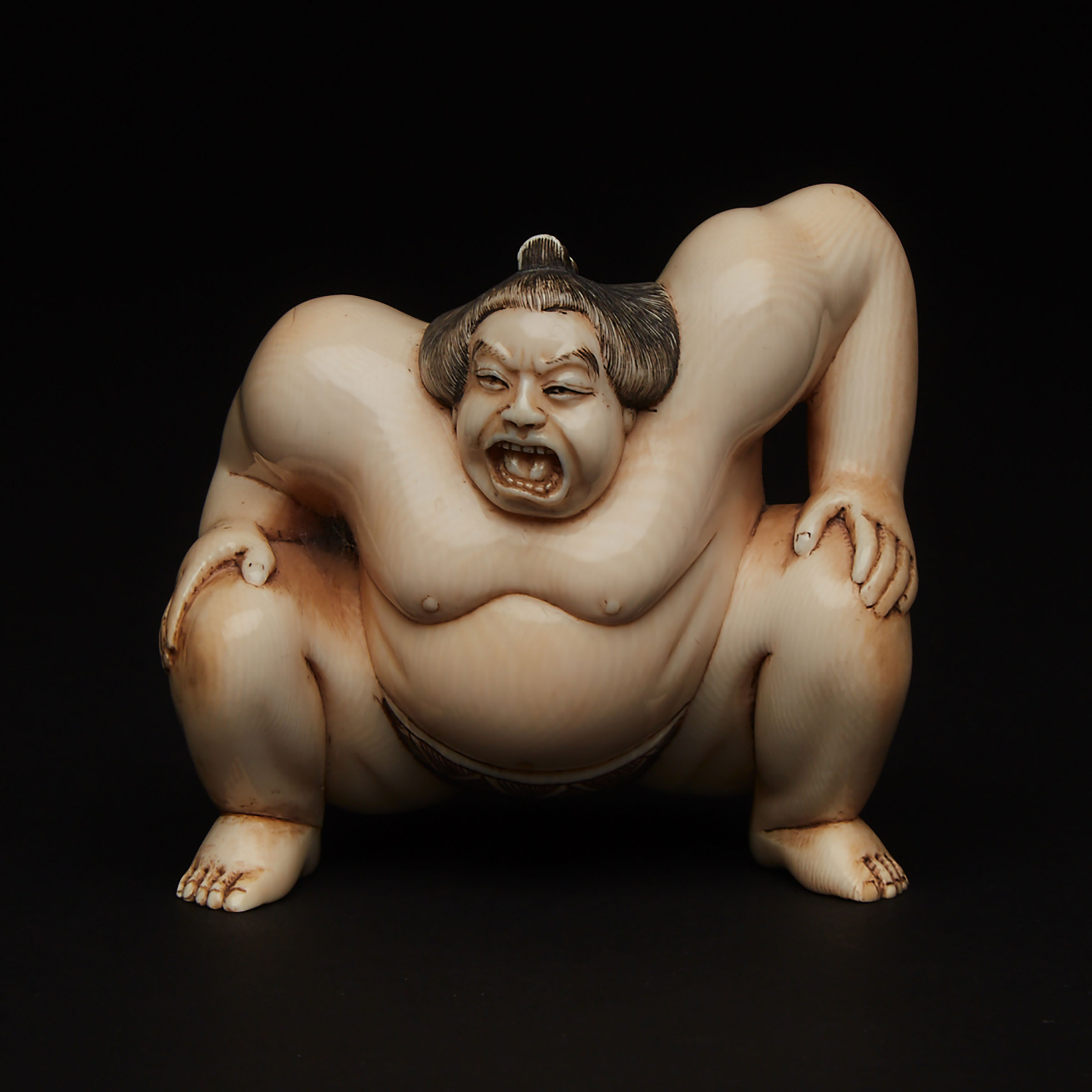 An Ivory Carved Okimono of a Sumo Wrestler
