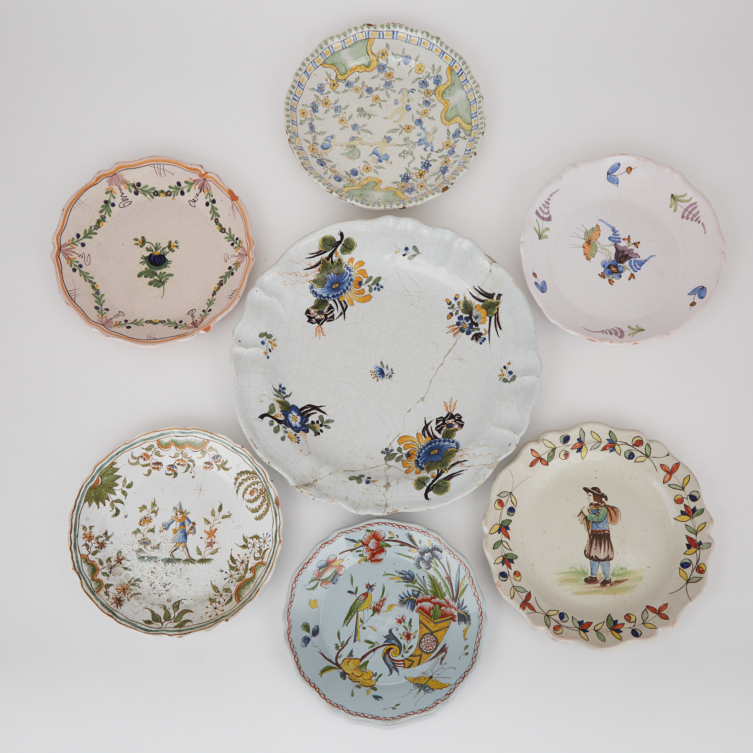 Six French Faience Plates and a German Charger, 18th/19th century