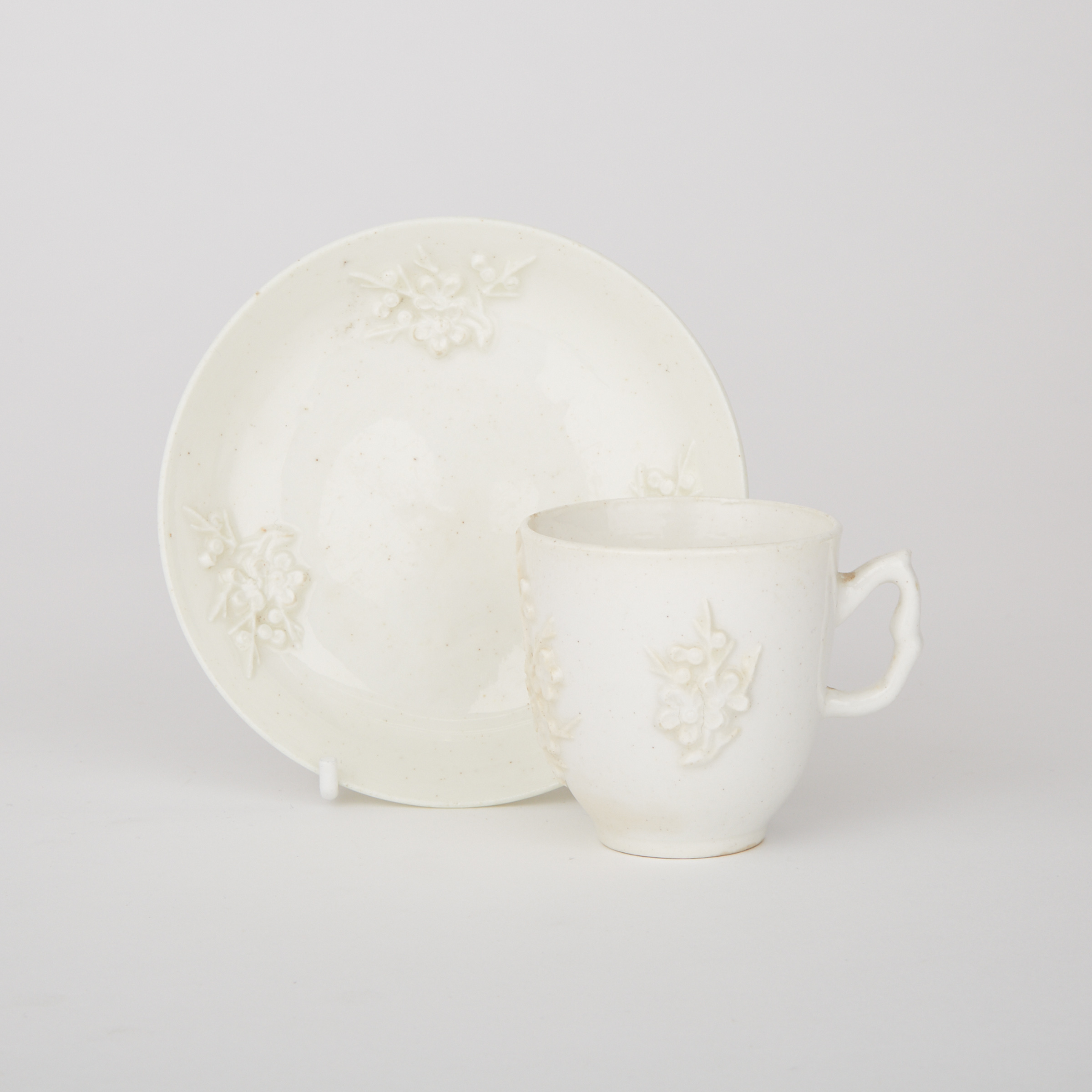 Bow White Glazed Moulded Prunus Cup and Saucer, c.1755