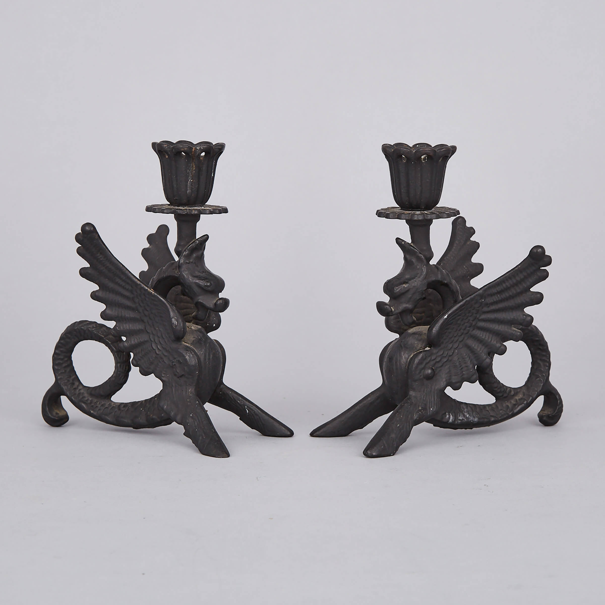 Pair of Renaissance Revival Cast Iron Gryphon Form Candlesticks, 20th century