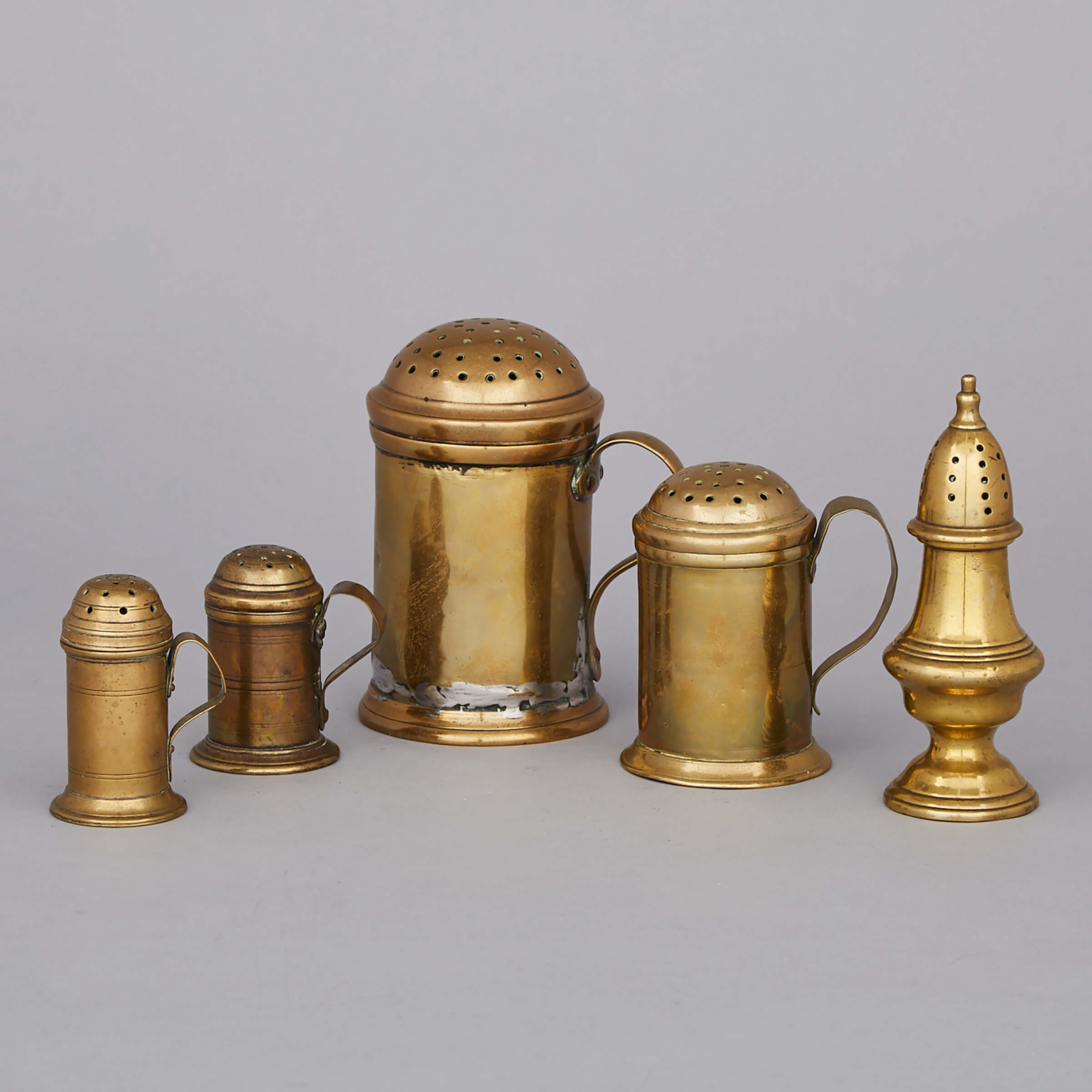Four English Brass Dredgers and a Castor, mid 18th century