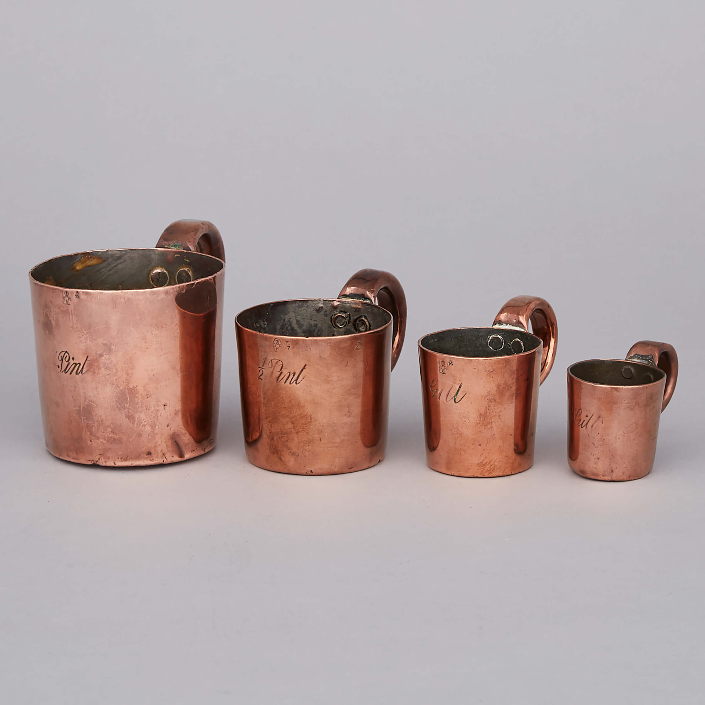 Set of Four Royal Navy Graduated Copper Rum Measures, early 19th century