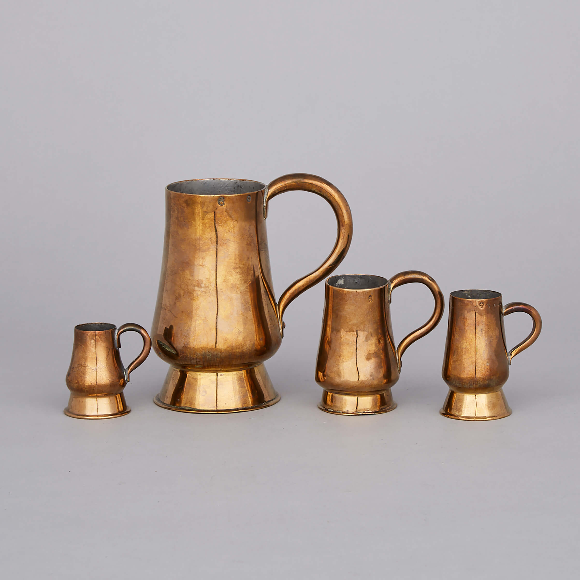 Four Scottish Brass Graduated Bombé Measures, 19th century