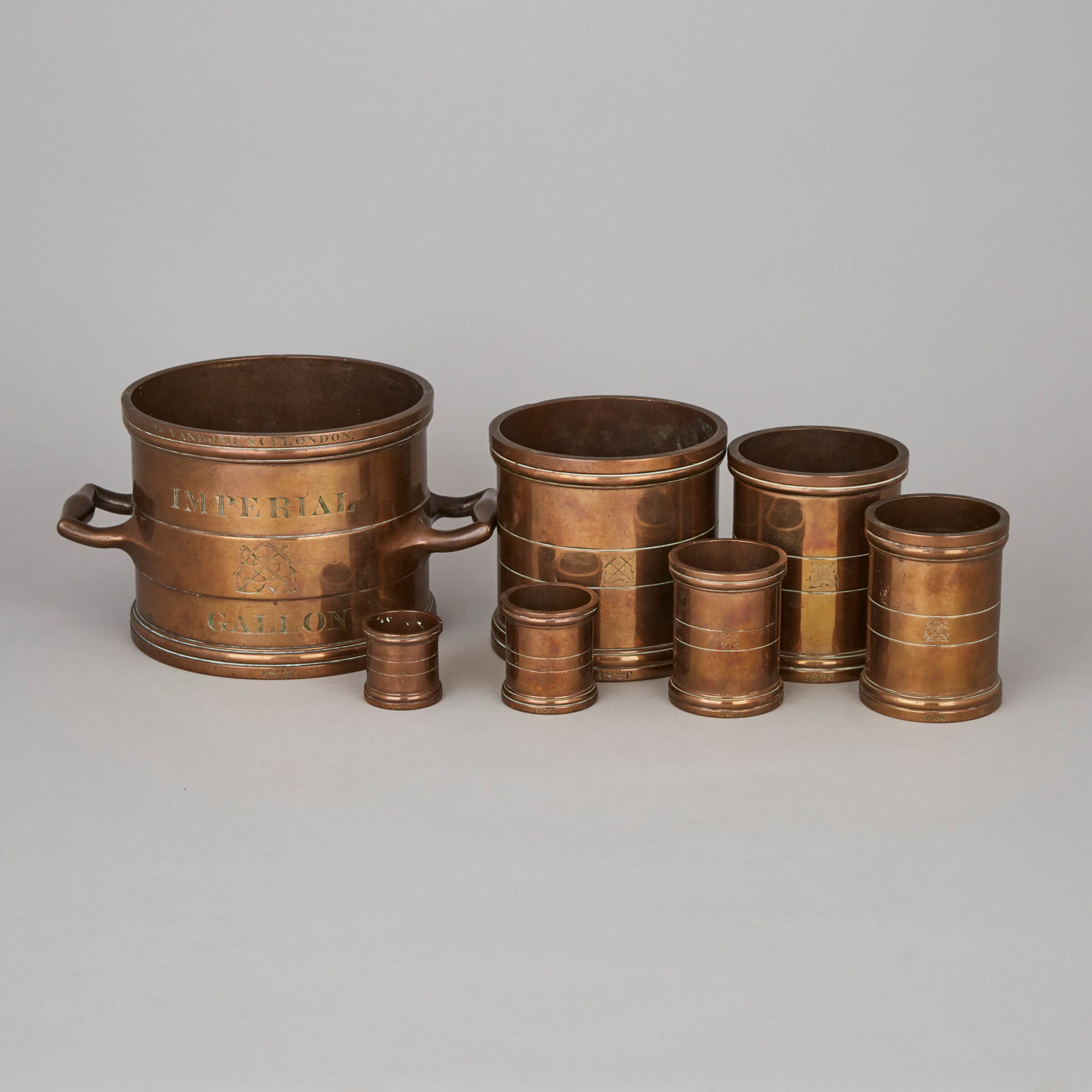 English Set of Seven Turned Brass Royal Navy Graduated Imperial Measures,  Rd. Vandome, London, 1826