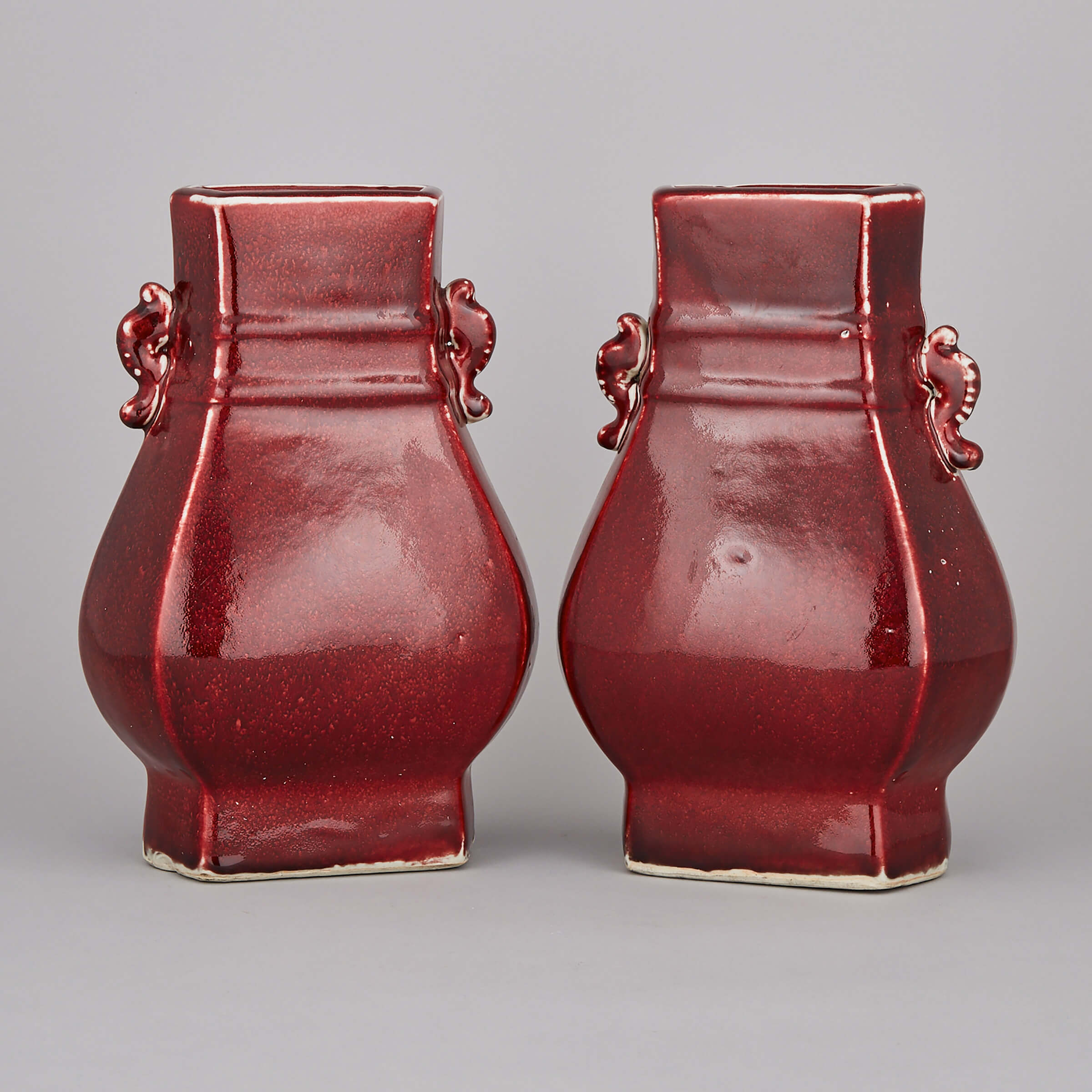 A Pair of Red Glazed Vases with Handles