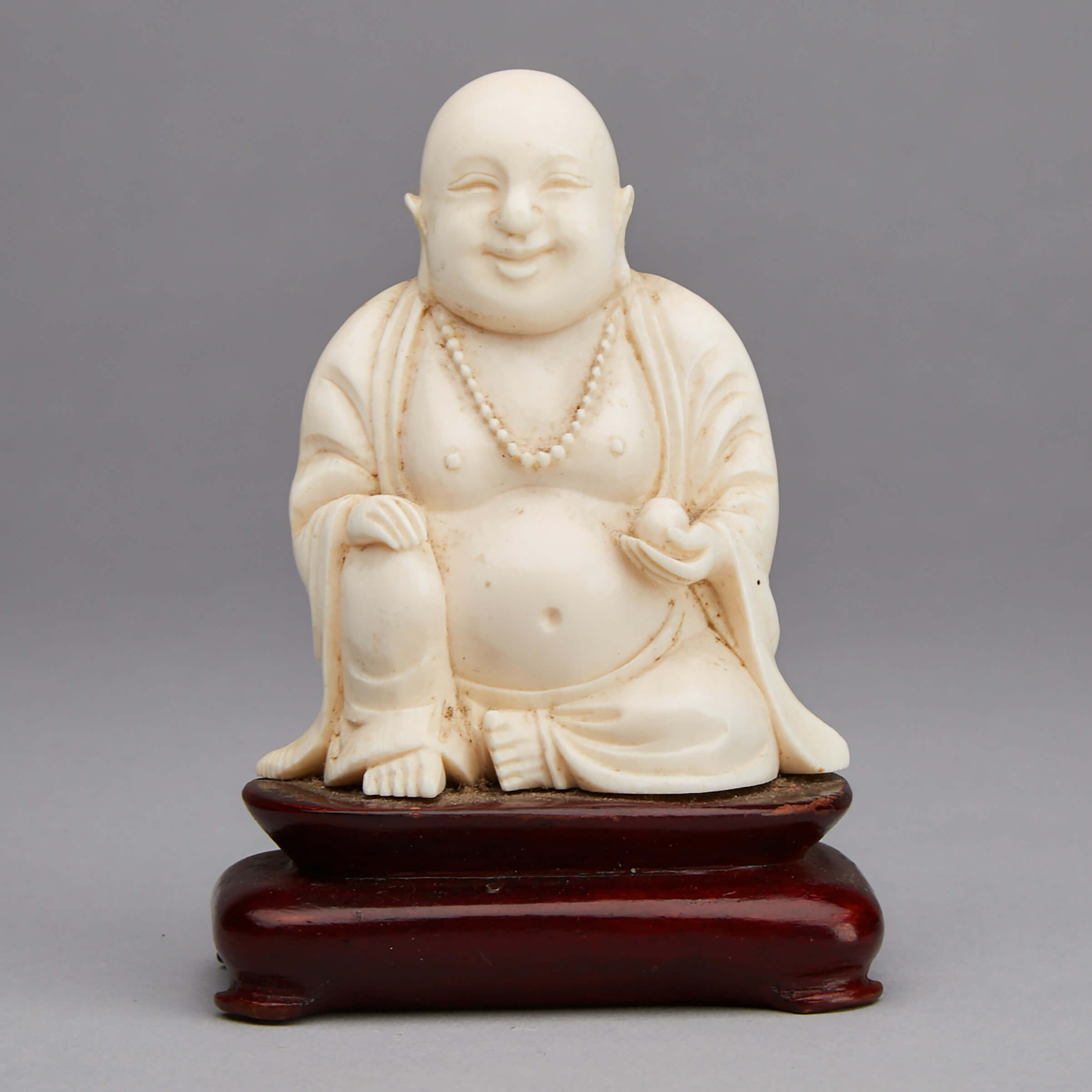 An Ivory Carved Laughing Buddha
