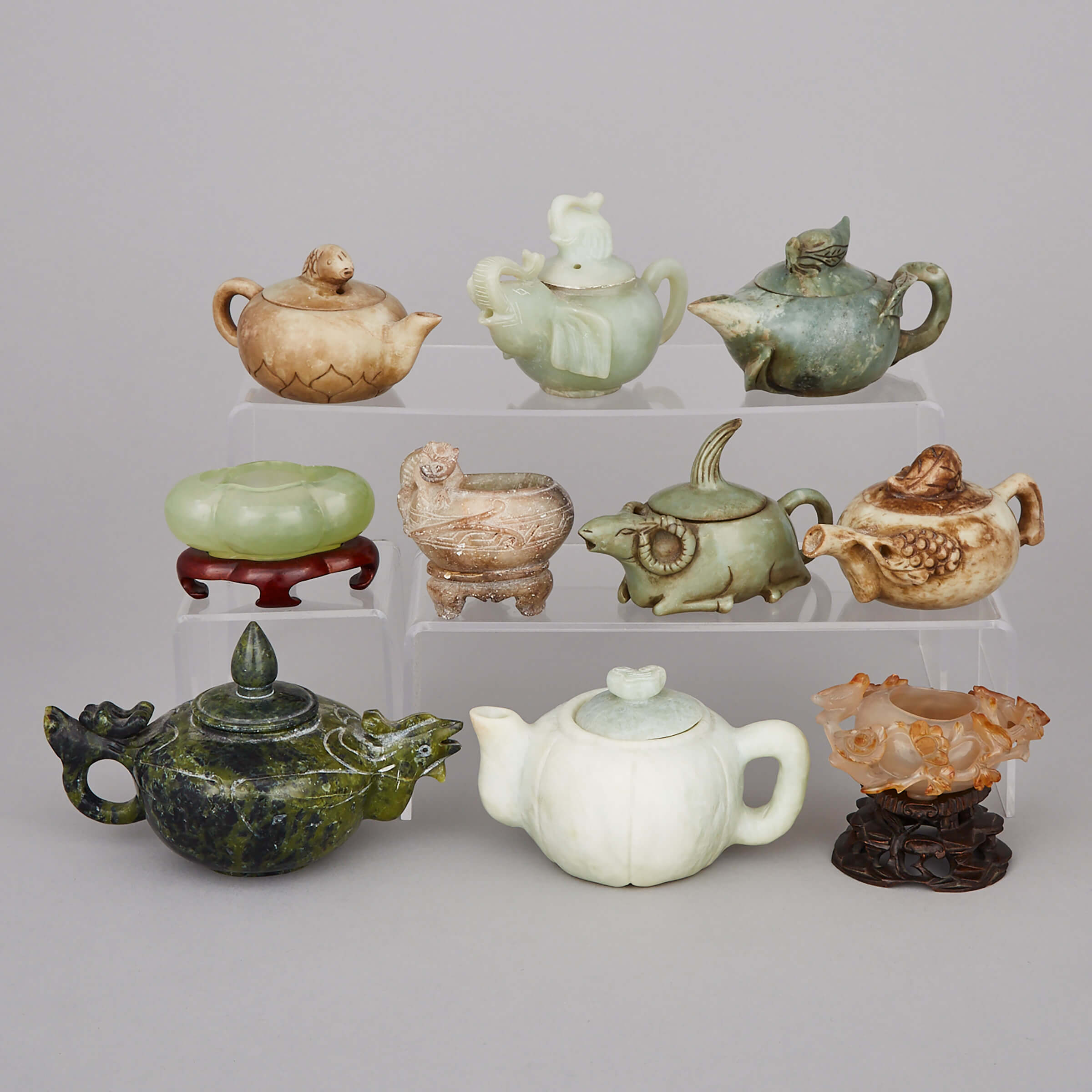 A Group of Ten Carved Teapots and Basins 