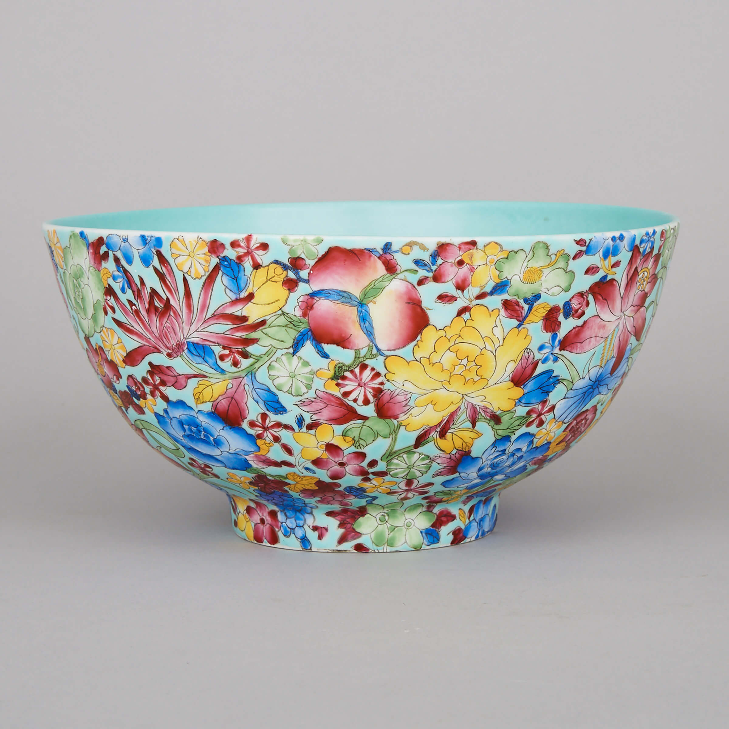 A Turquoise-Ground Famille Rose Peach and Flowers Punch Bowl