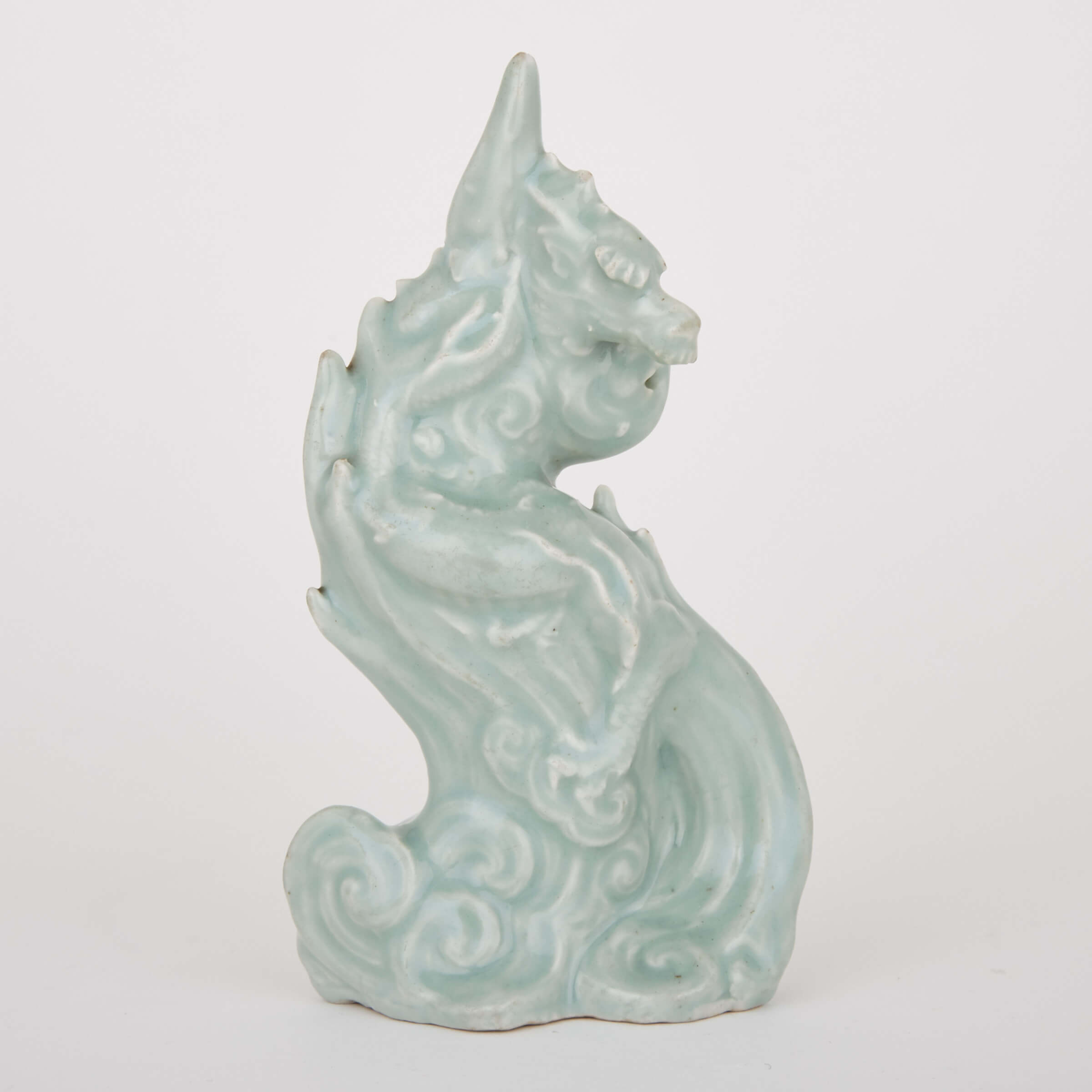 A Rare and Finely Moulded Celadon Glazed Porcelain Dragon, 19th Century