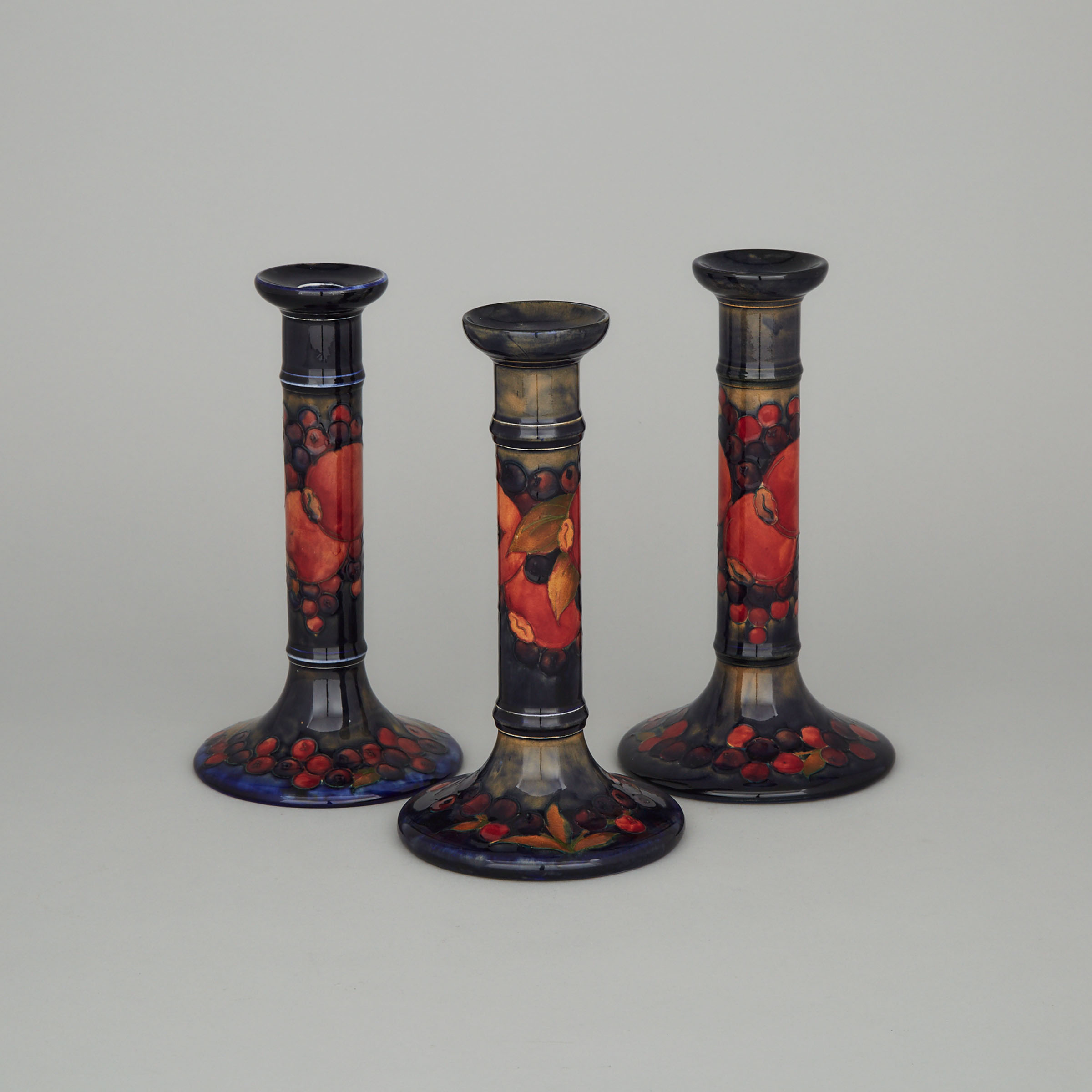Three Moorcroft Pomegranate Table Candlesticks, c.1925